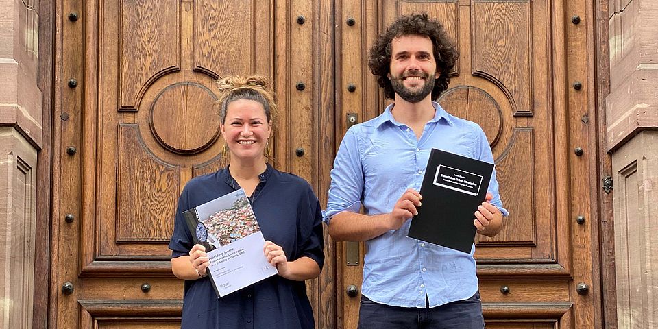 doctorate candidates with their theses in hand