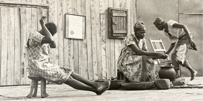 Three people in front of a building