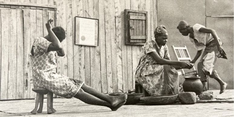 Three people in front of a building